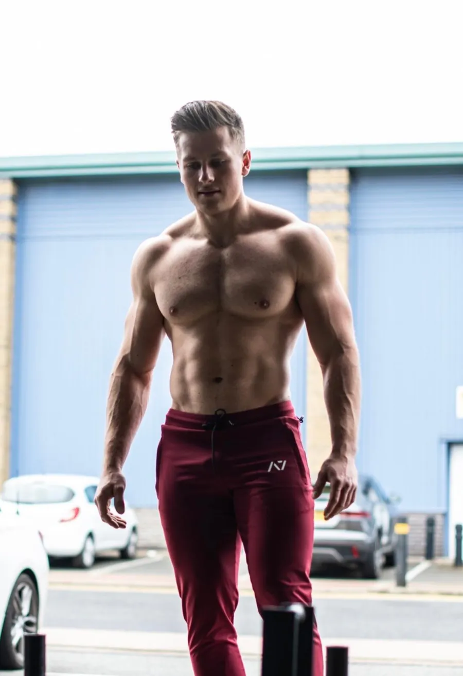 Mike’s physique, shirtless, outside a warehouse gym