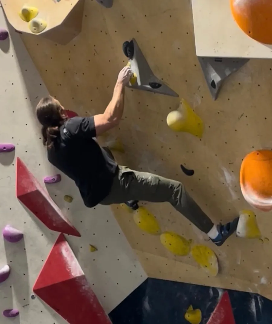 Mike bouldering on an indoor climbing wall